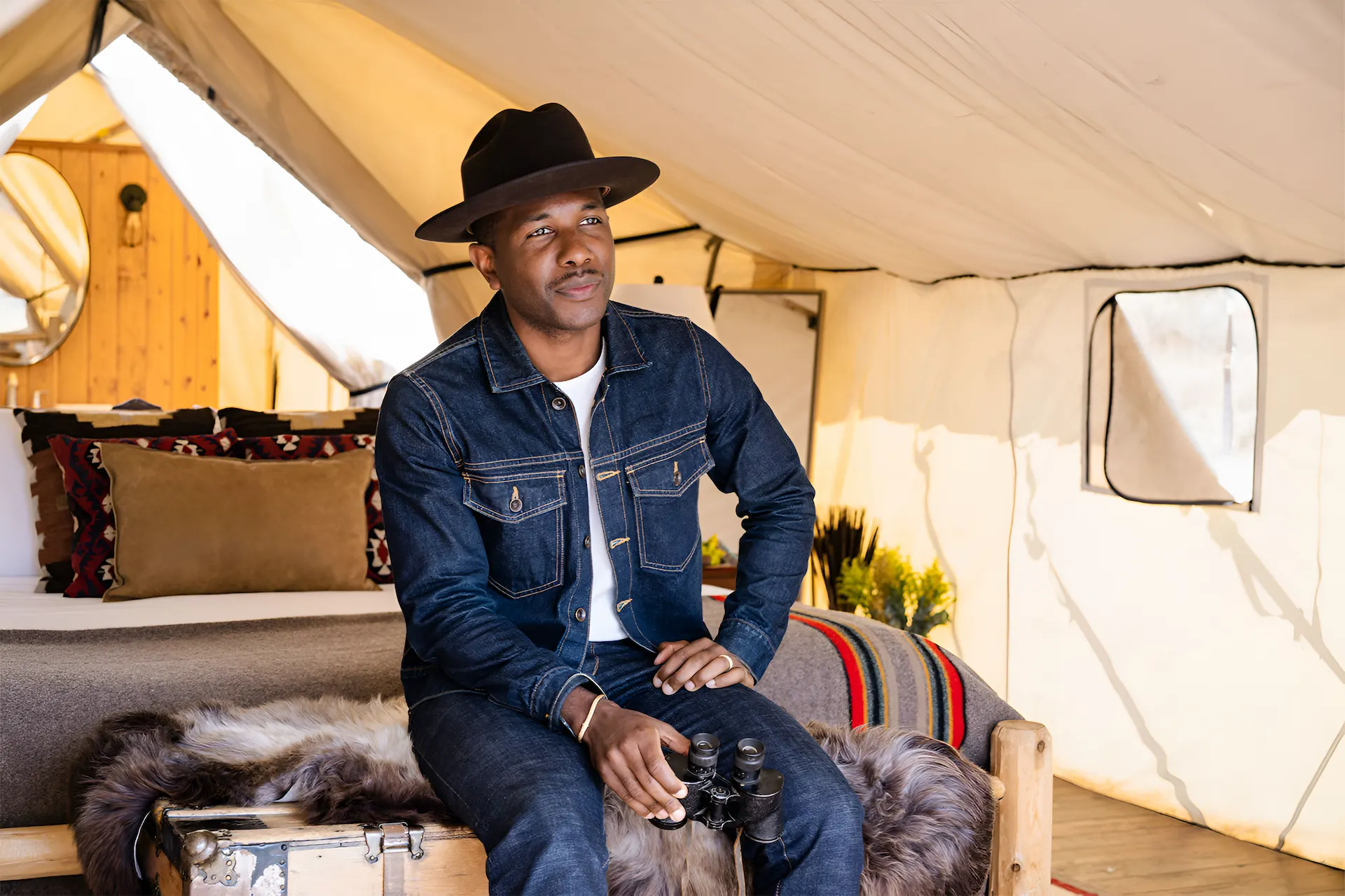 Man dressed in western style in a tent