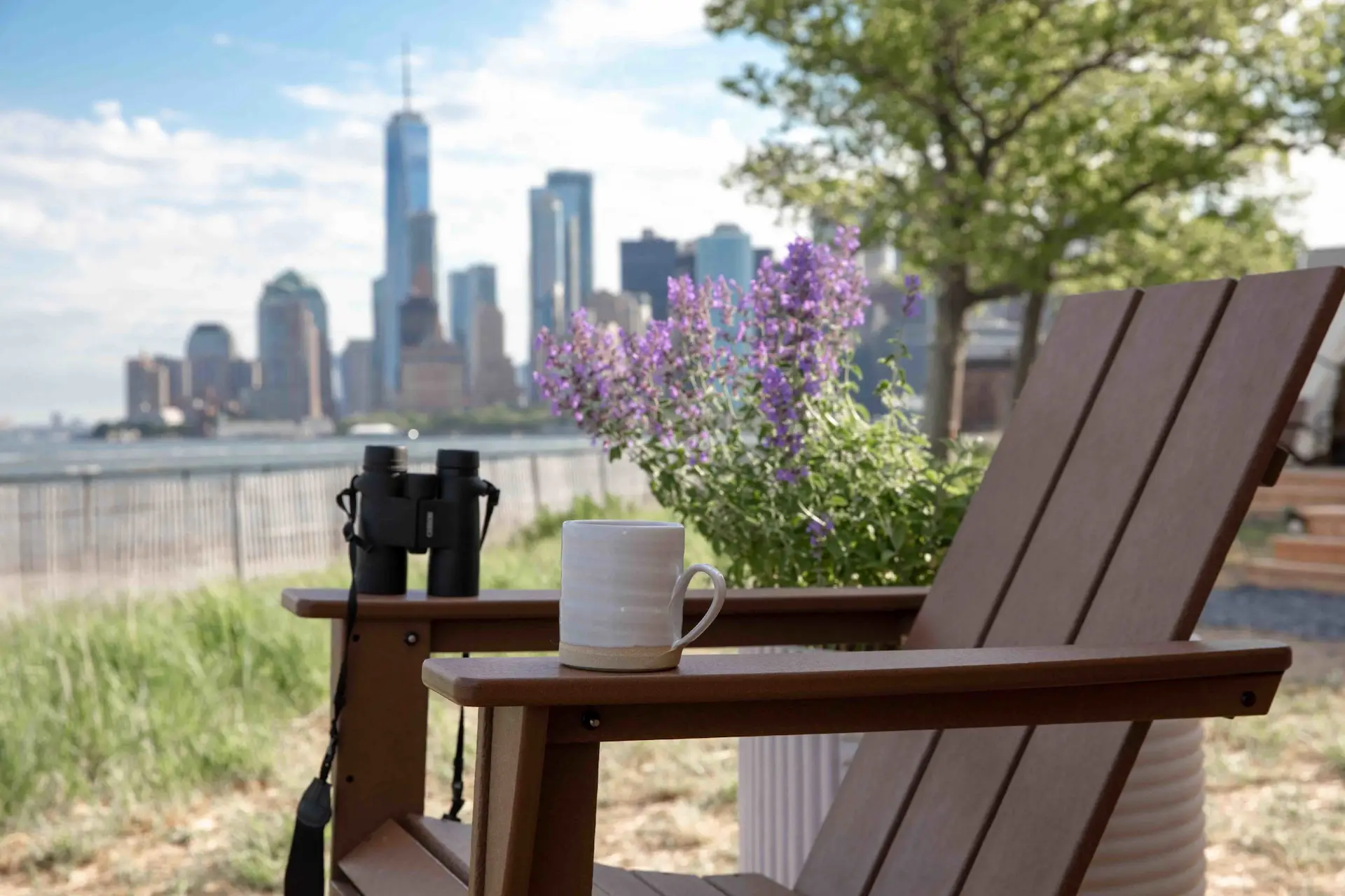 Close up chair and freedom tower from Governors Island